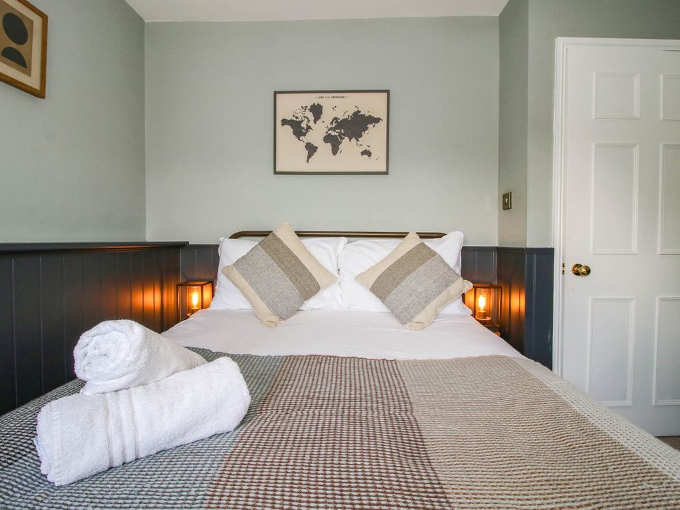 A bedroom with a bed and pillows at The Lodge in Shawbury