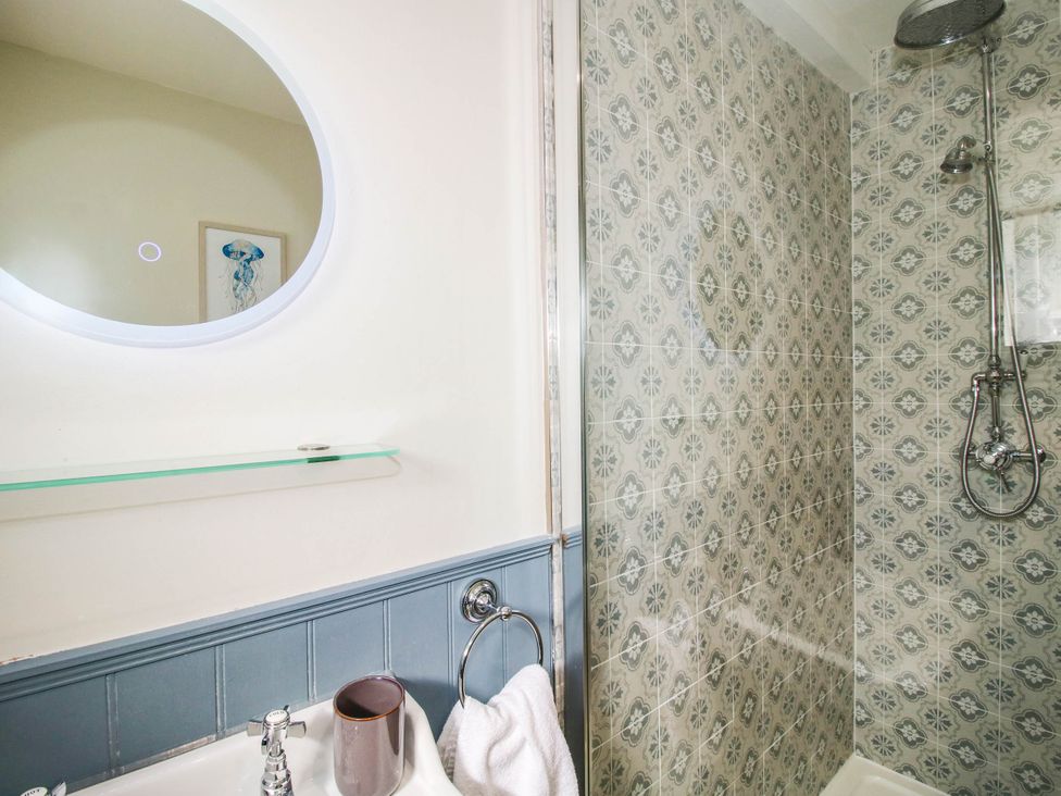 A bathroom with a shower and a mirror at The Lodge in Shawbury