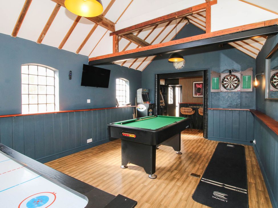 A game room with a pool table and air hockey table at The Lodge in Shawbury