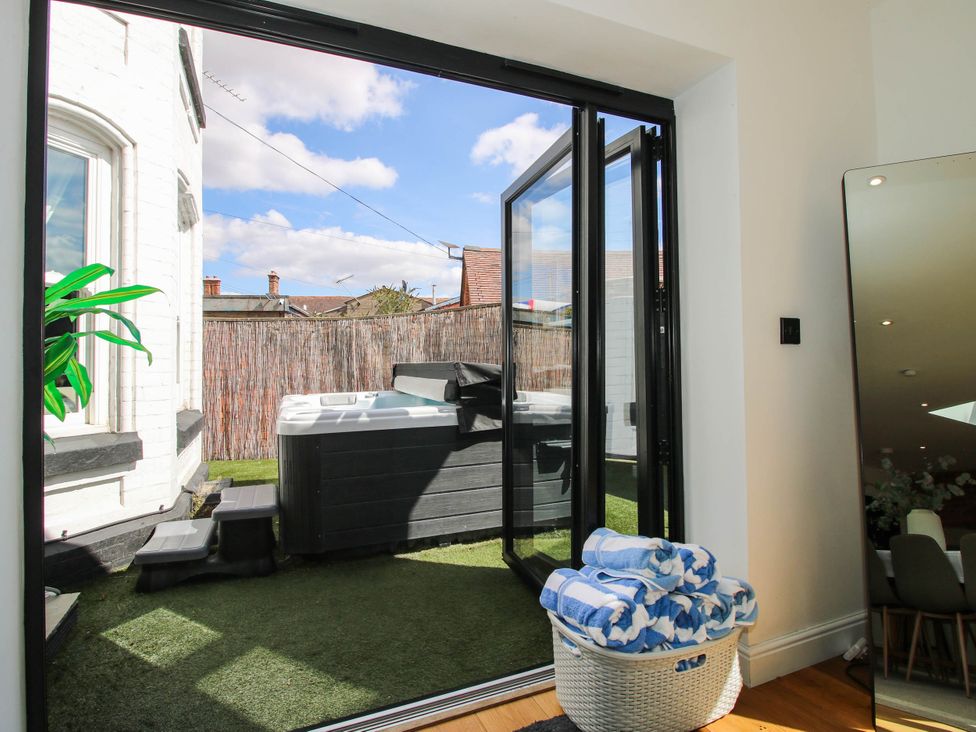 A room with a hot tub and towels at The Lodge in Shawbury