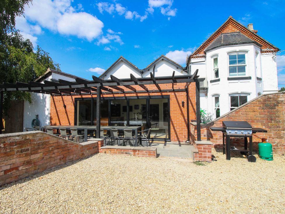 An outdoor area with a dining table and chairs at The Lodge in Shawbury