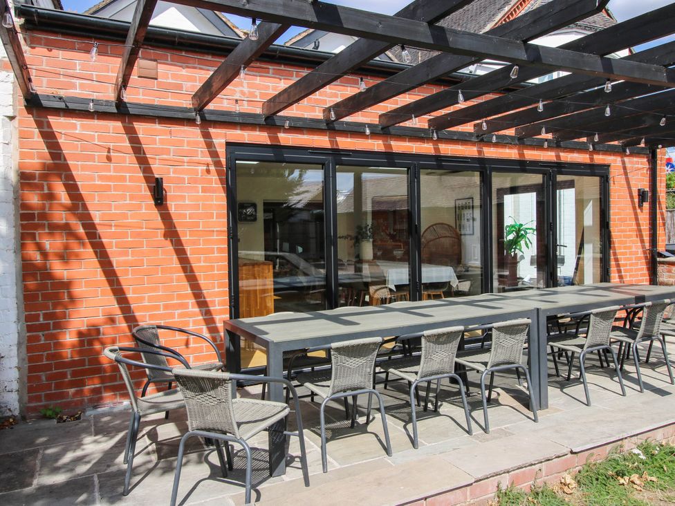 An outdoor dining area with a table and chairs at The Lodge in Shawbury