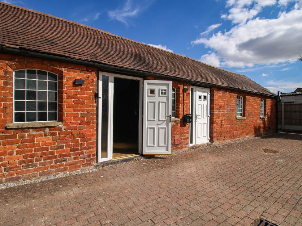 An exterior view of a brick building with doors and windows at The Lodge in Shawbury