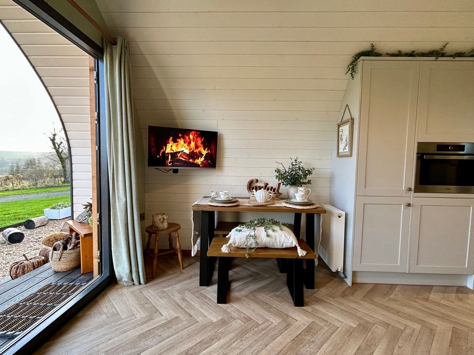 A dining area with table and chairs at Willow in Llangurig near Llanidloes