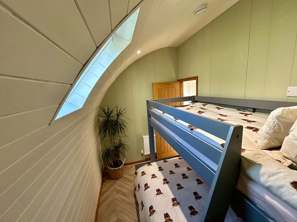 A bedroom with a bunk bed and a window at Willow, Llangurig near Llanidloes