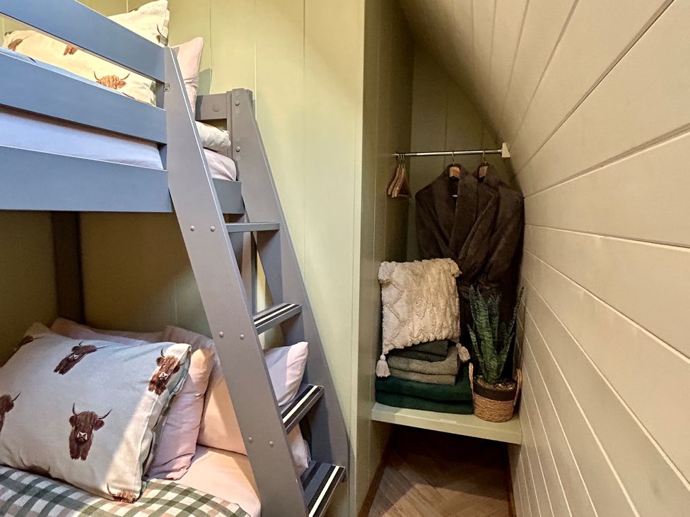 A bunk bed with pillows and towels at Willow in Llangurig near Llanidloes