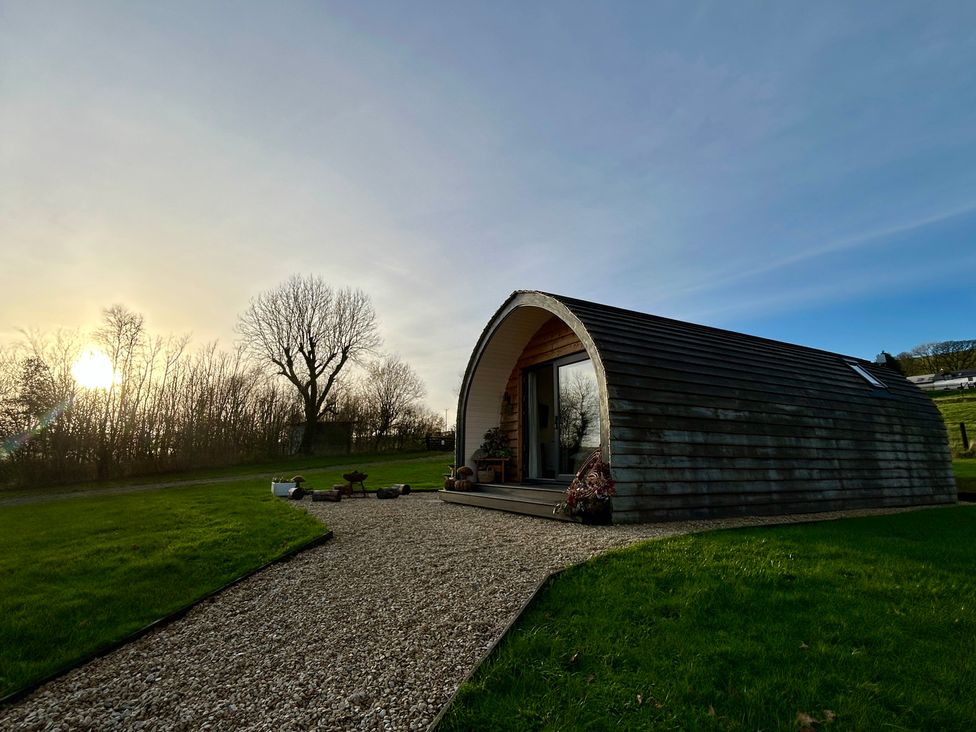 A pod-shaped building with a pathway in front at Willow in Llangurig near Llanidloes
