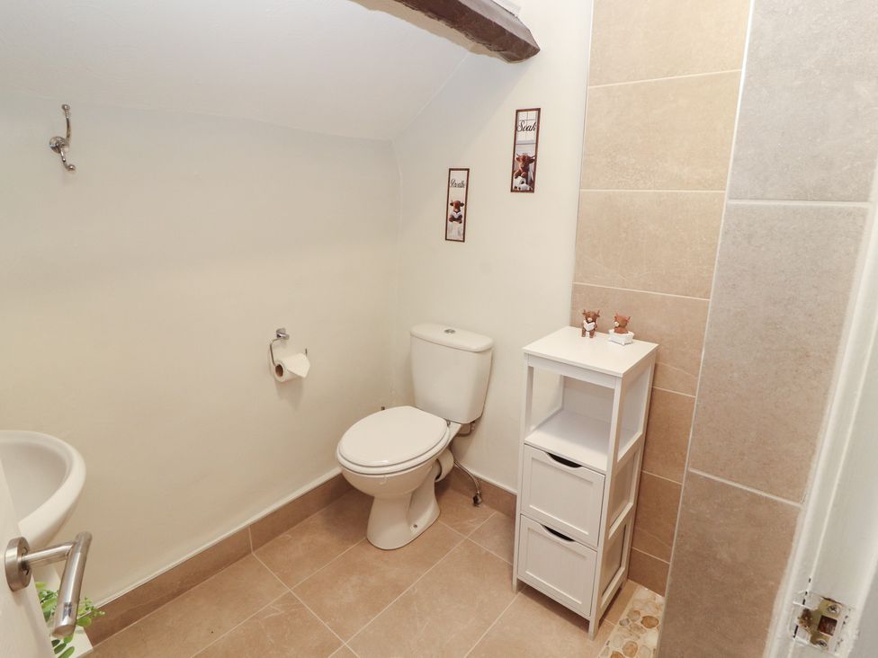 A bathroom with a toilet and hand wash basin at River Cottage Eamont Bridge