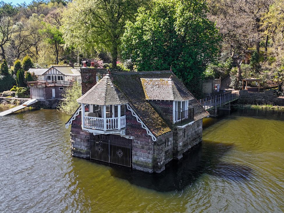 A house on the water with a bridge at Lady Of The Lake Rudyard Lake