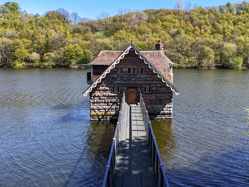 A house on water with a bridge at Lady Of The Lake in Rudyard Lake