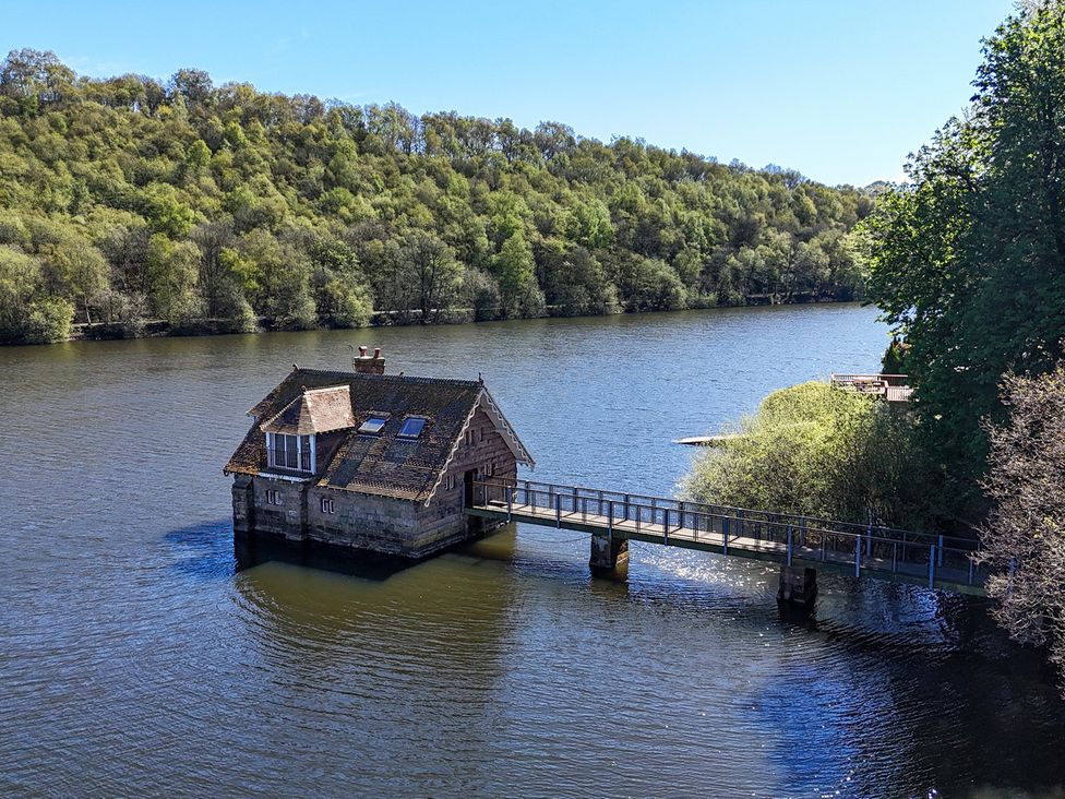 A house on water with a bridge at Lady Of The Lake in Rudyard Lake