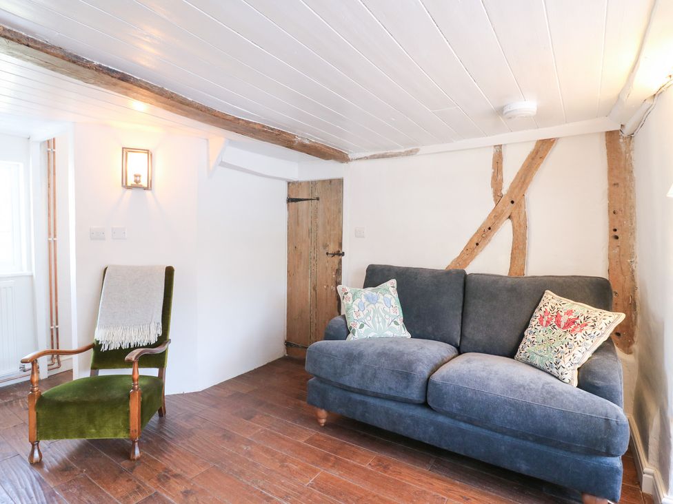 A living room with a sofa and armchair at 66 High Street Cambridge