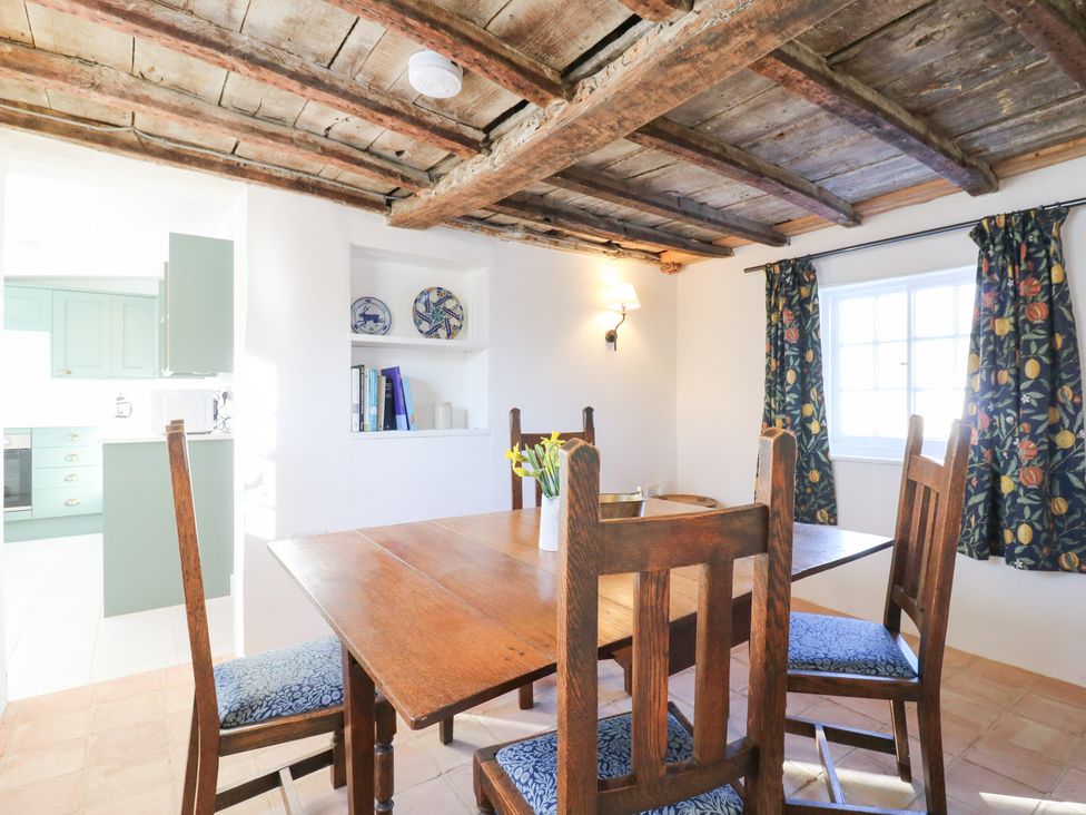 A dining room with a wooden table and chairs at 66 High Street Cambridge