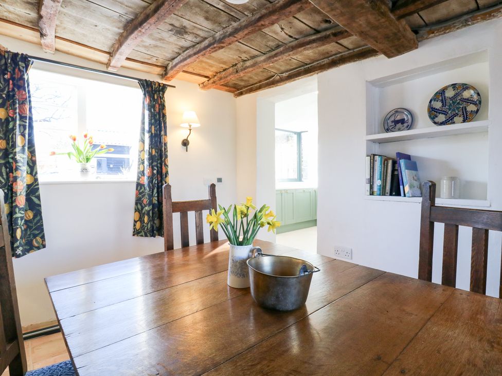 A dining room with a wooden table and chairs at 66 High Street in Cambridge