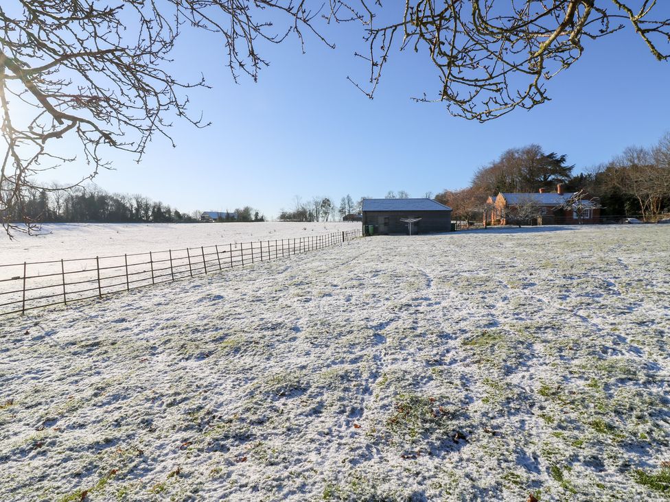 An outdoor scene with a snow-covered field and buildings at 66 High Street in Cambridge