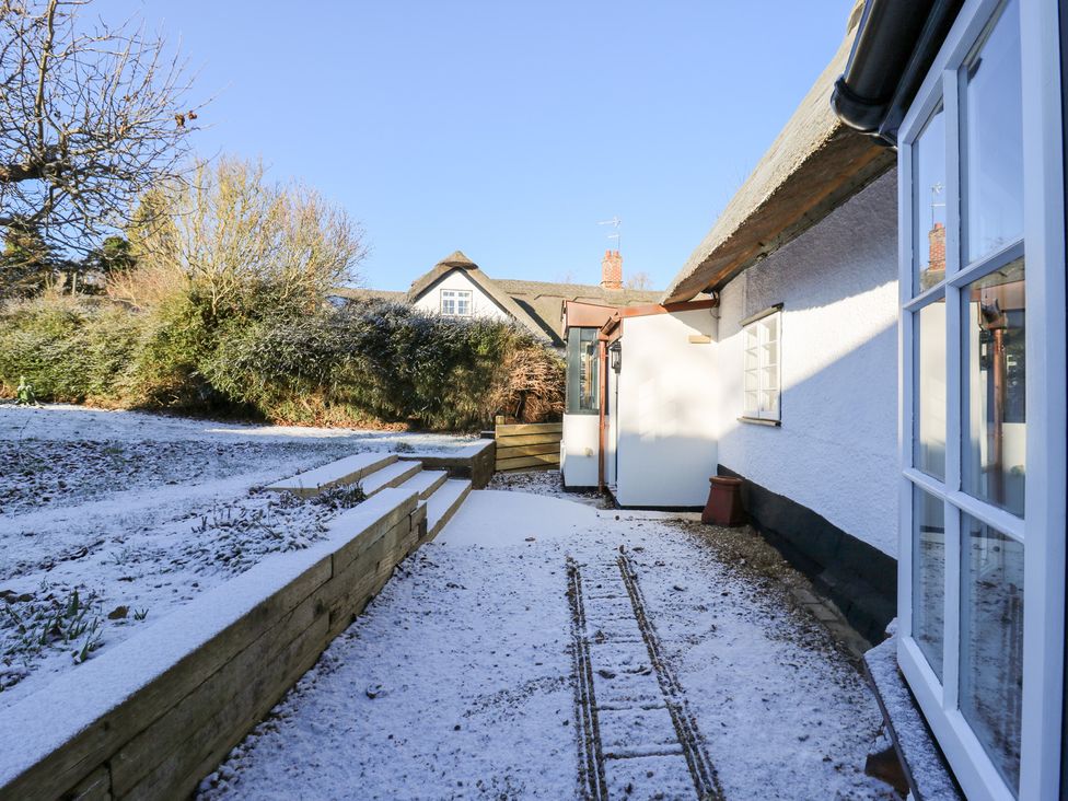 An outdoor view of a house with snow in the garden at 66 High Street, Cambridge