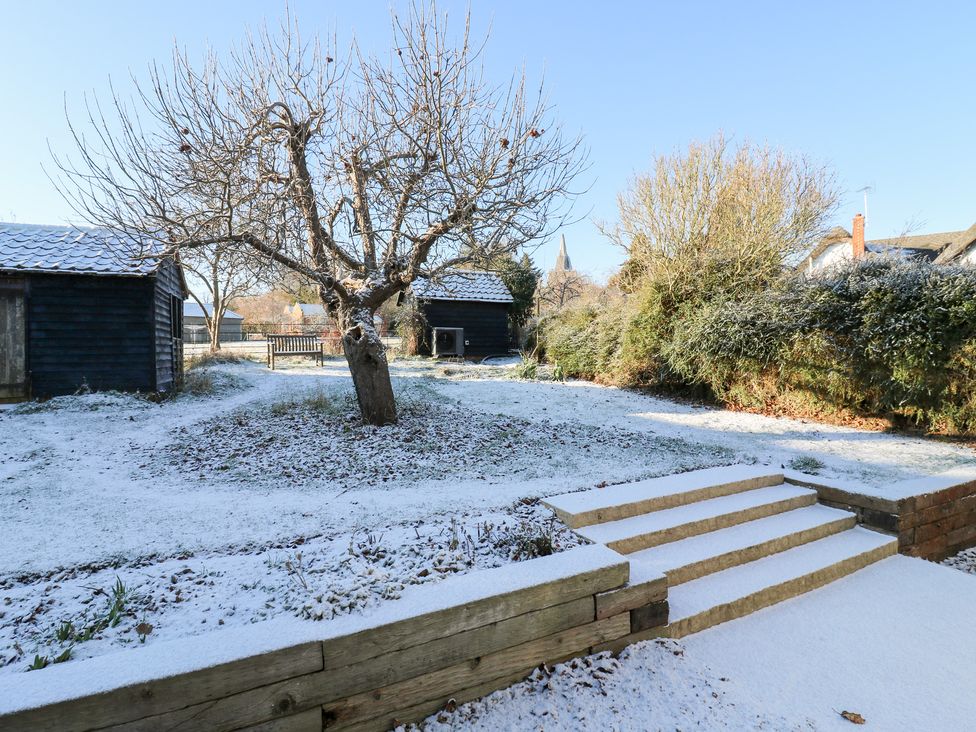 A garden with snow-covered ground and steps at 66 High Street Cambridge