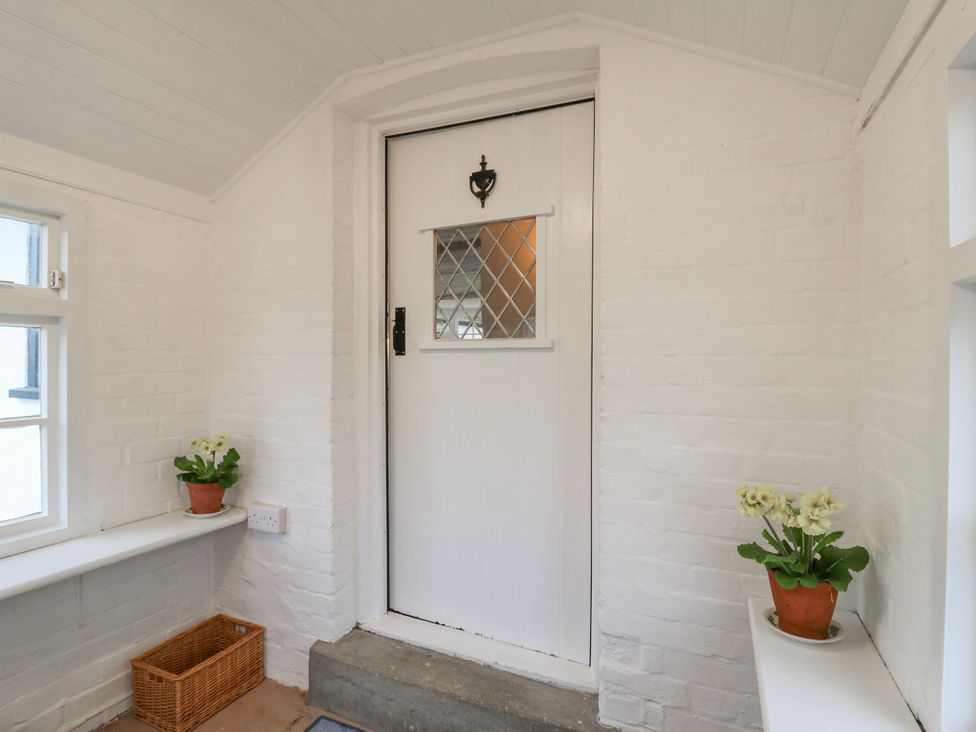 An entrance hall with a door and plants at The Old Smithy in Bourn