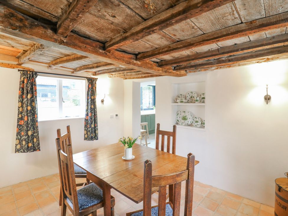 A dining room with a wooden table and chairs at The Old Smithy in Bourn