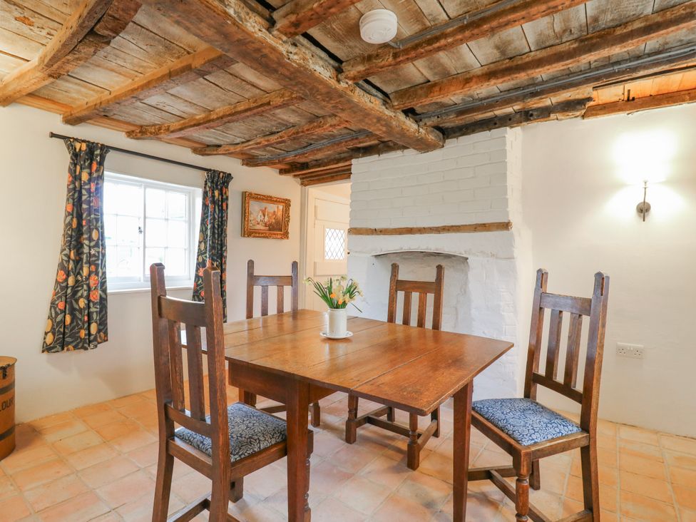 A dining room with a table and chairs at The Old Smithy in Bourn