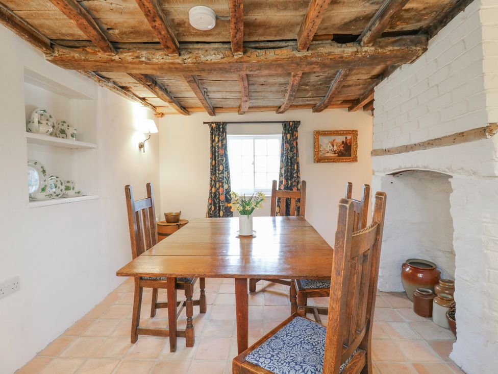 A dining room with a wooden table and chairs at The Old Smithy in Bourn