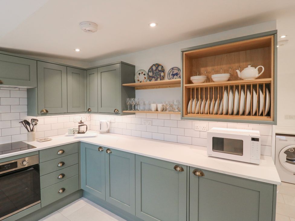 A kitchen with cabinets and appliances at The Old Smithy in Bourn