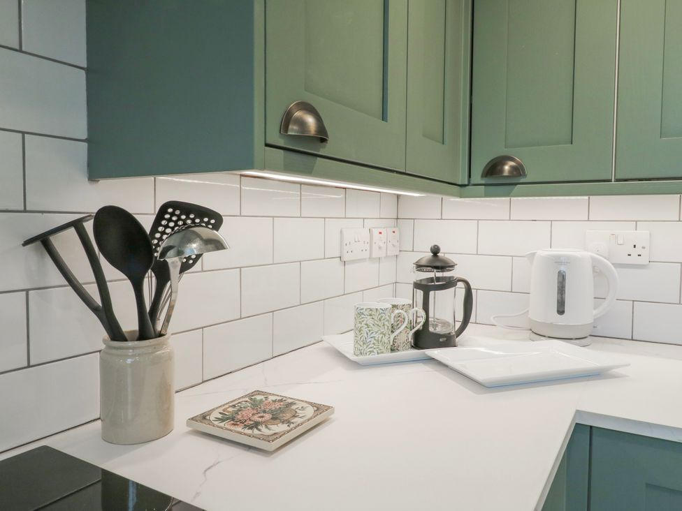 A kitchen counter with utensils and appliances at The Old Smithy in Bourn