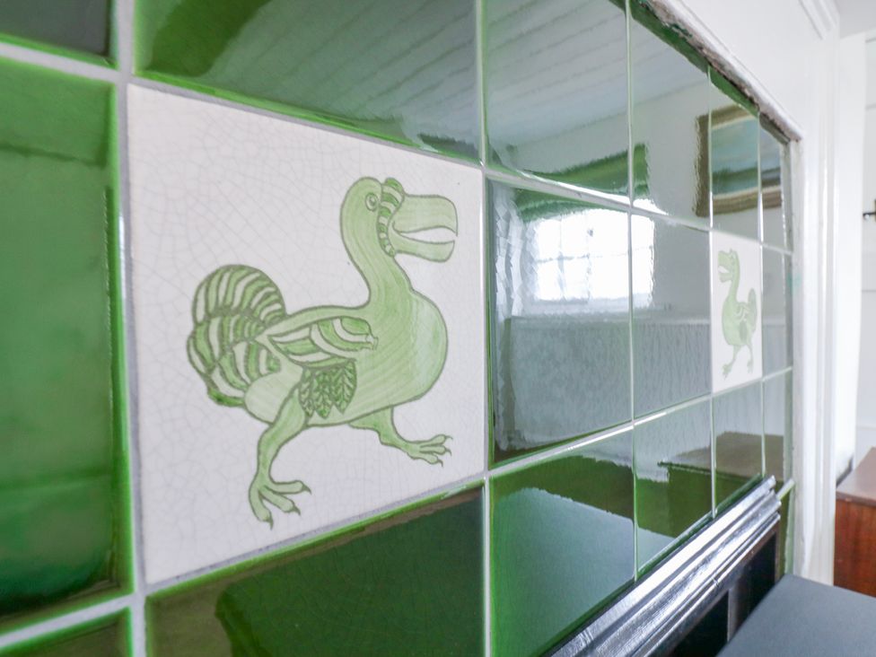 An illustration of a dodo on green tiles at The Old Smithy in Bourn
