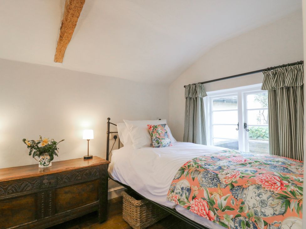 A bedroom with a bed and a dresser at The Old Smithy in Bourn