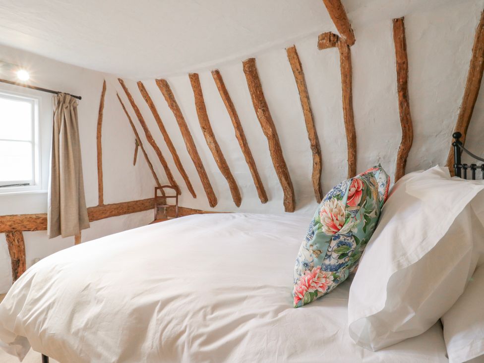 A bedroom with a bed and a window at The Old Smithy in Bourn