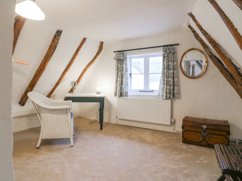 An attic with a chair and desk at The Old Smithy in Bourn