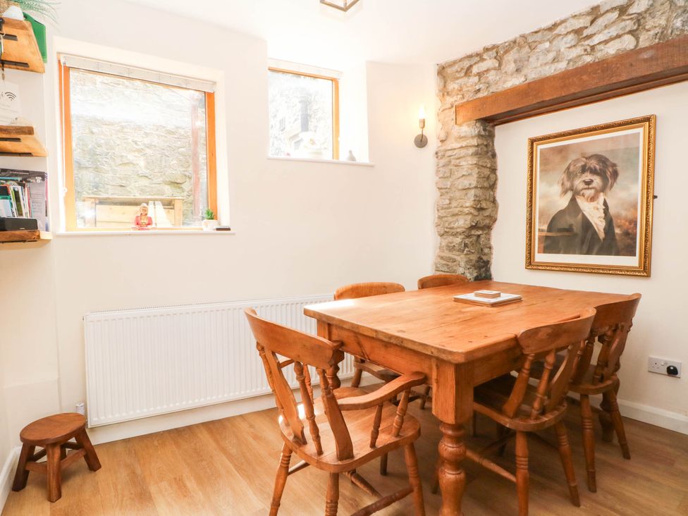 A dining room with a wooden table and chairs at The Cottage O'ergate in Bradwell