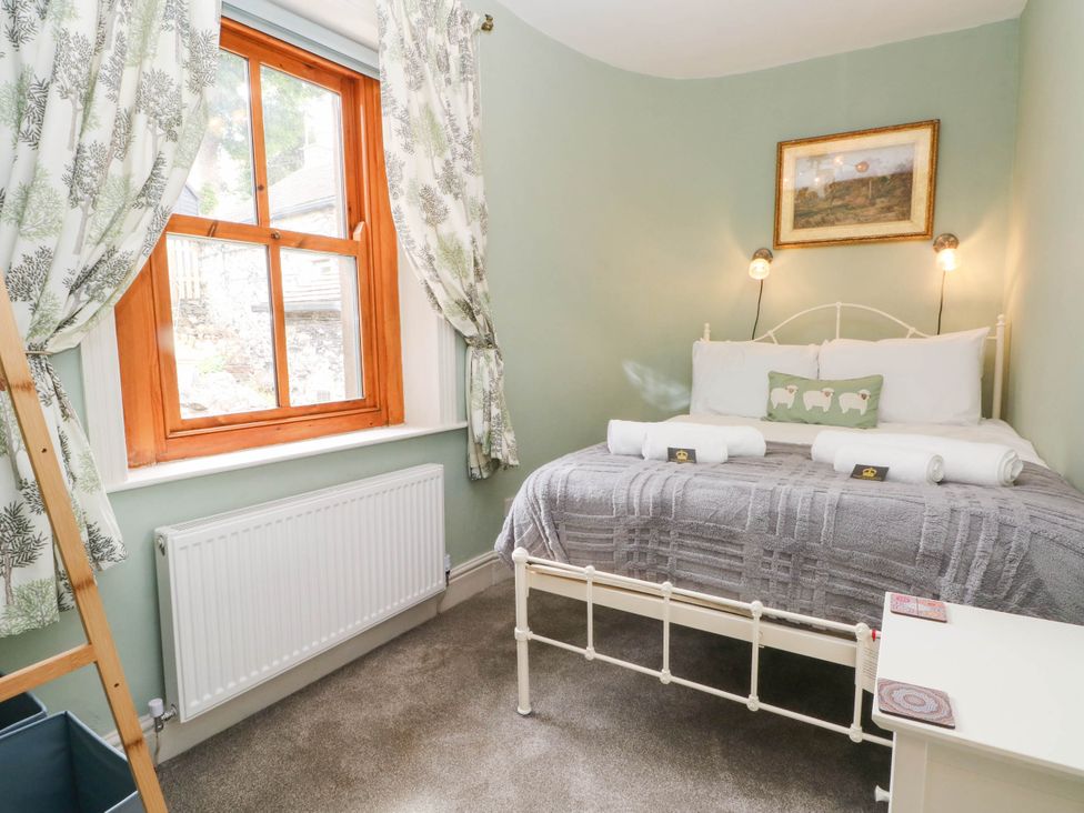 A bedroom with a bed and window at The Cottage O'ergate in Bradwell