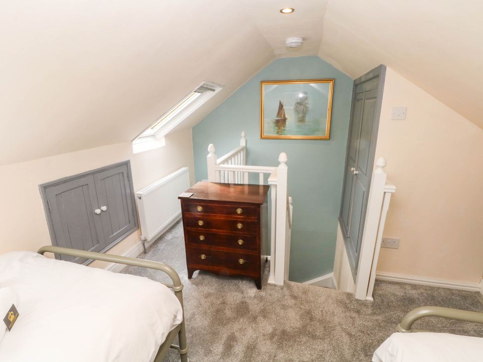 A loft area with a bed and chest of drawers at The Cottage O'ergate in Bradwell