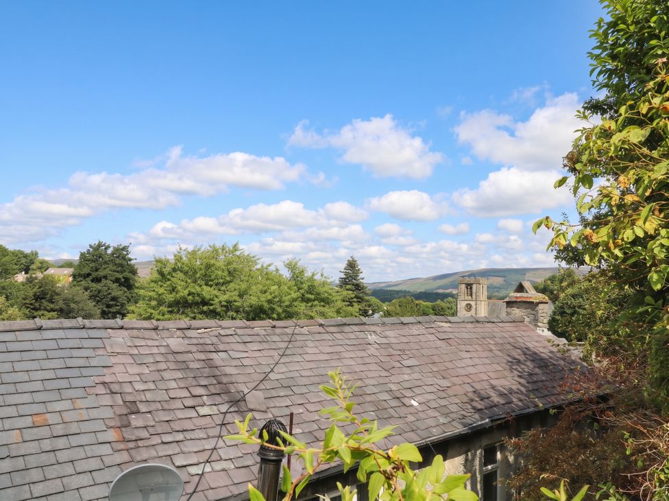 A view of a roof trees and mountains at The Cottage O'ergate in Bradwell