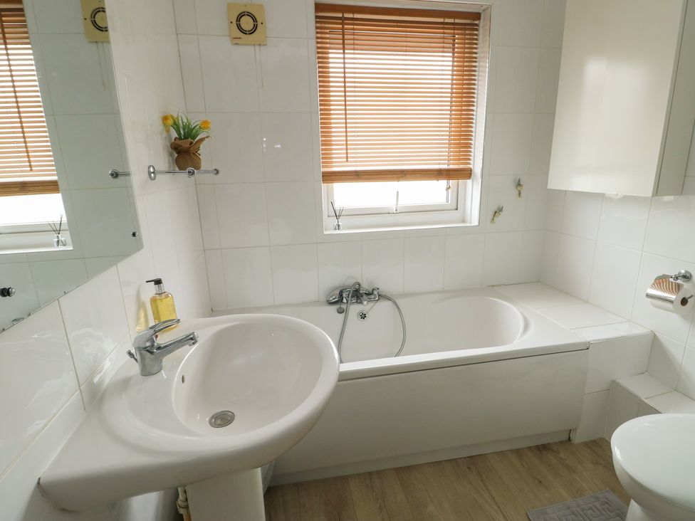 A bathroom with a sink and bathtub at Ty Haf Trearddur Bay