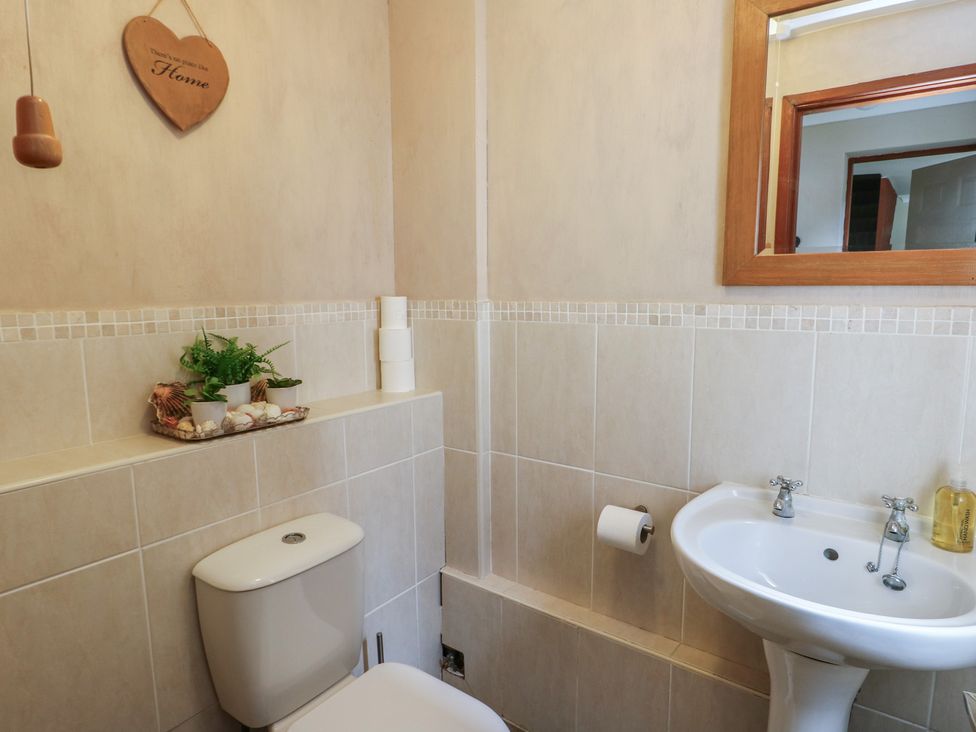 A bathroom with a toilet and sink at Ty Haf in Trearddur Bay