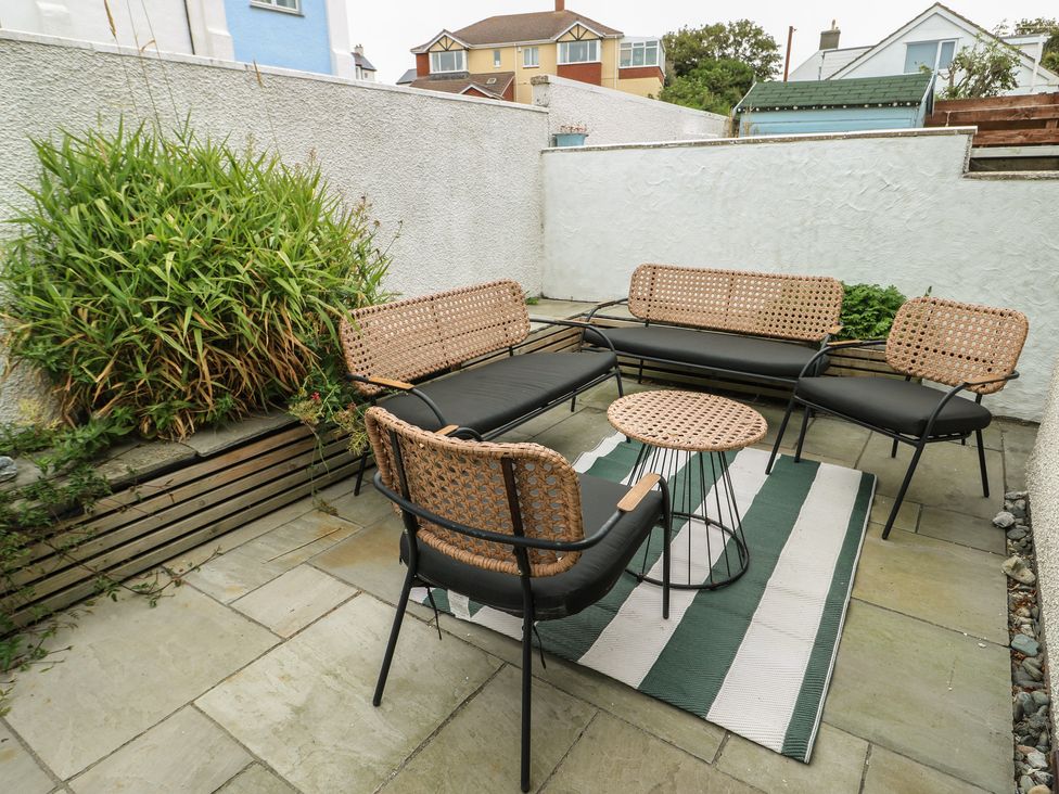 A garden seating area with a sofa, chairs, and a table at Ty Haf in Trearddur Bay