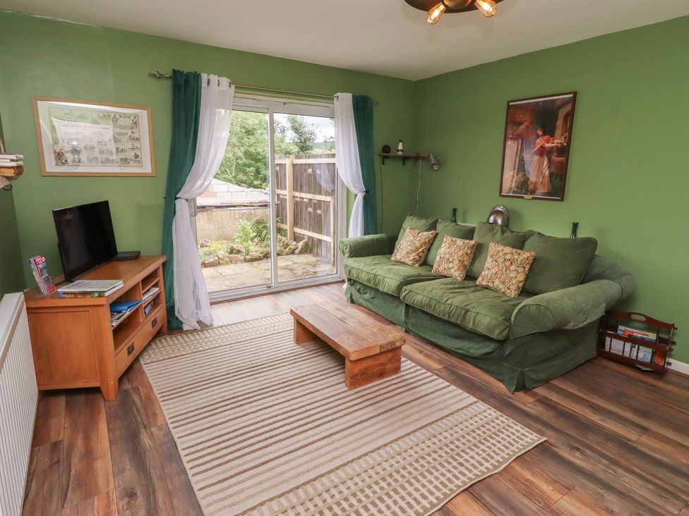 A living room with a sofa and television at Flodden Apartment in Wooler
