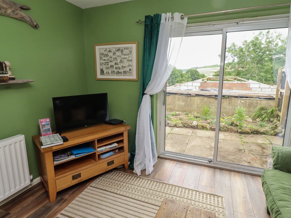 A living room with a television and a sofa at Flodden Apartment in Wooler