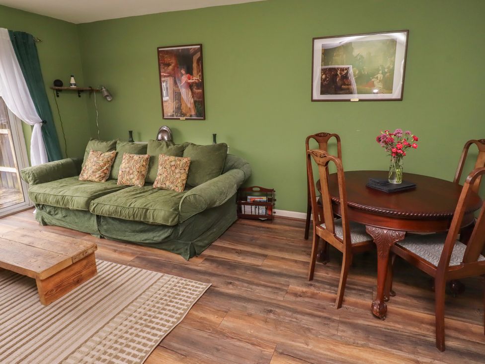 A living room with a sofa and dining table at Flodden Apartment in Wooler