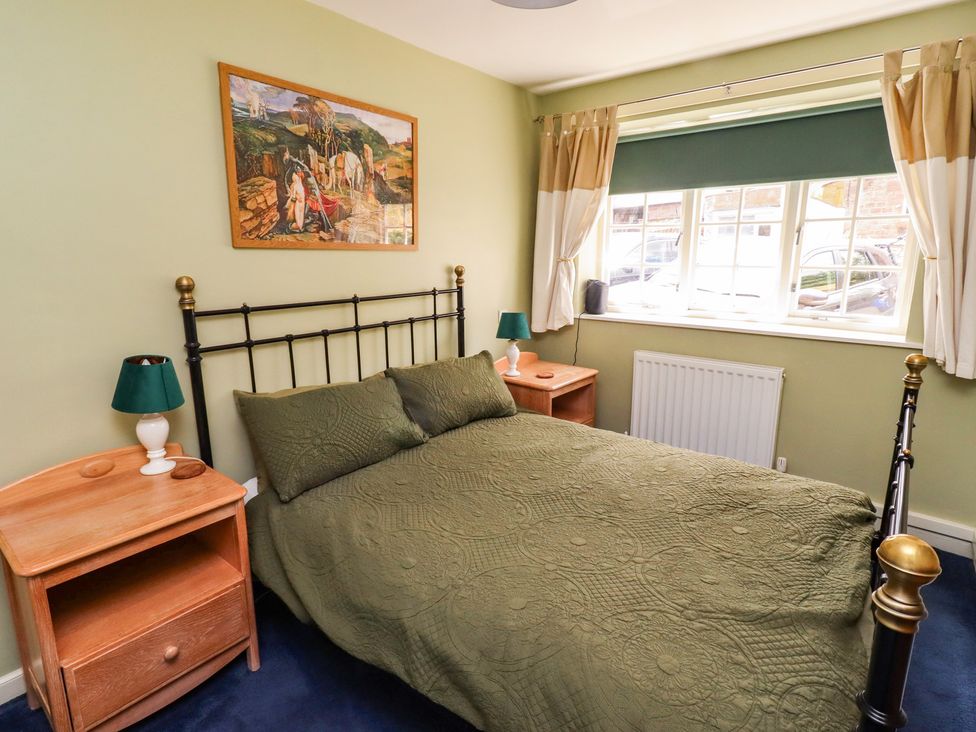 A bedroom with a bed and nightstands at Flodden Apartment in Wooler