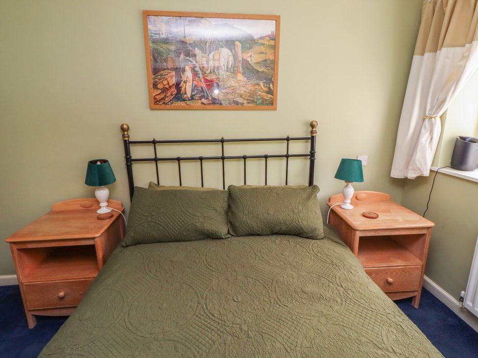 A bedroom with a bed and bedside tables at Flodden Apartment in Wooler