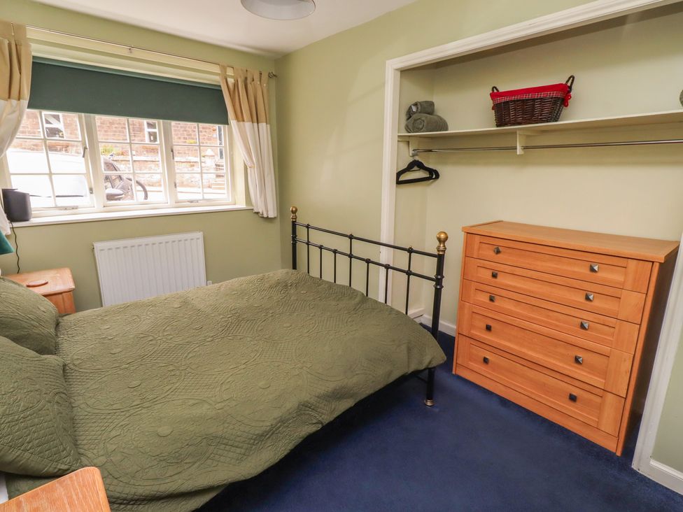 A bedroom with a bed and a drawer at Flodden Apartment in Wooler