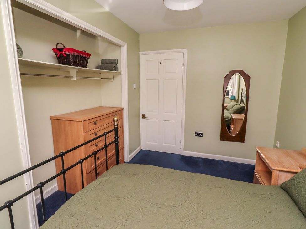 A bedroom with a bed and a drawer chest at Flodden Apartment in Wooler