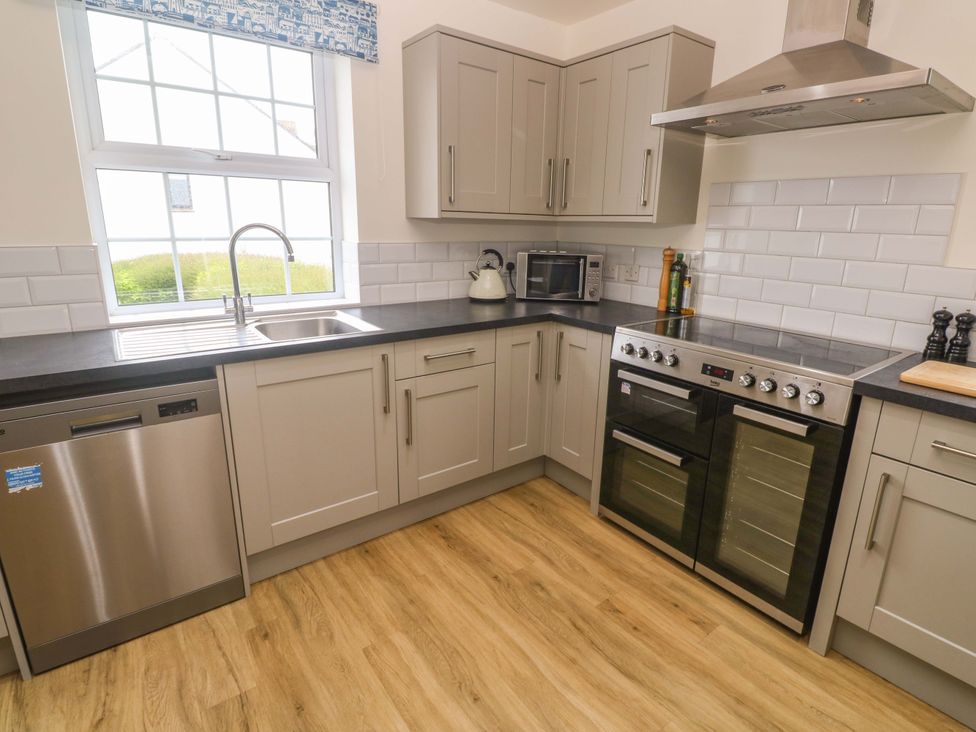 A kitchen with appliances and window at Fair View St Just in Roseland near St Mawes