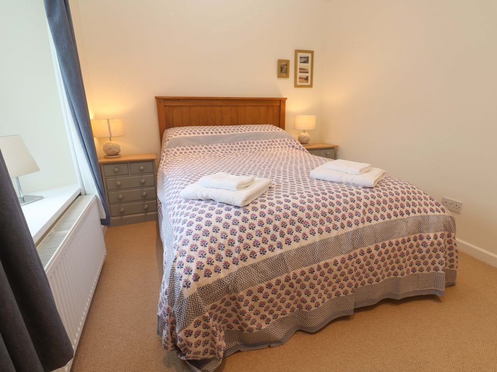 A bedroom with a bed and bedside tables at Fair View in St Just in Roseland near St Mawes