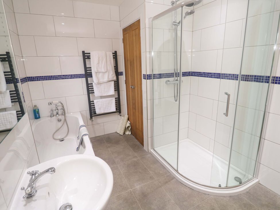 A bathroom with a bathtub and shower at Fair View in St Just in Roseland near St Mawes