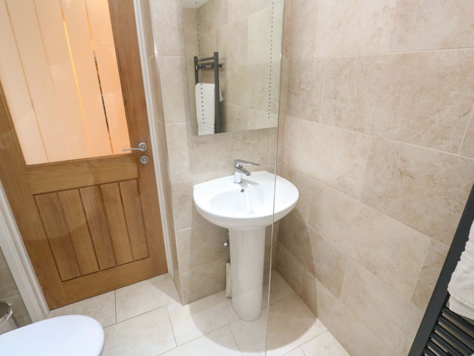 A bathroom with a sink and shower in Fair View St Just in Roseland near St Mawes