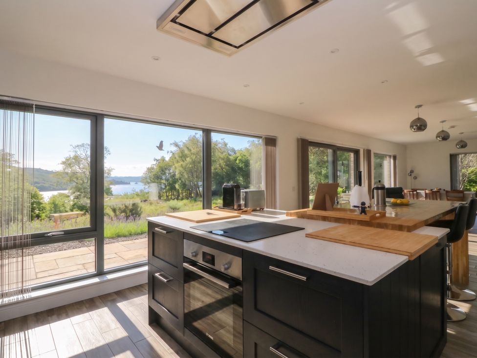 A kitchen with appliances and a view at Taigh Creag Thulach in Taynuilt